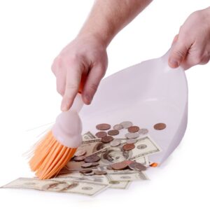 someone sweeping up money into a dustpan