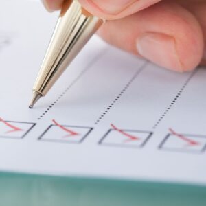 using a pen to check off items in a list