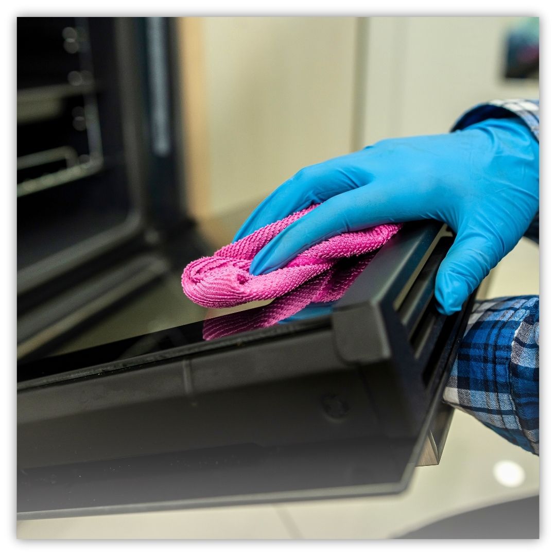 a person cleaning a stove