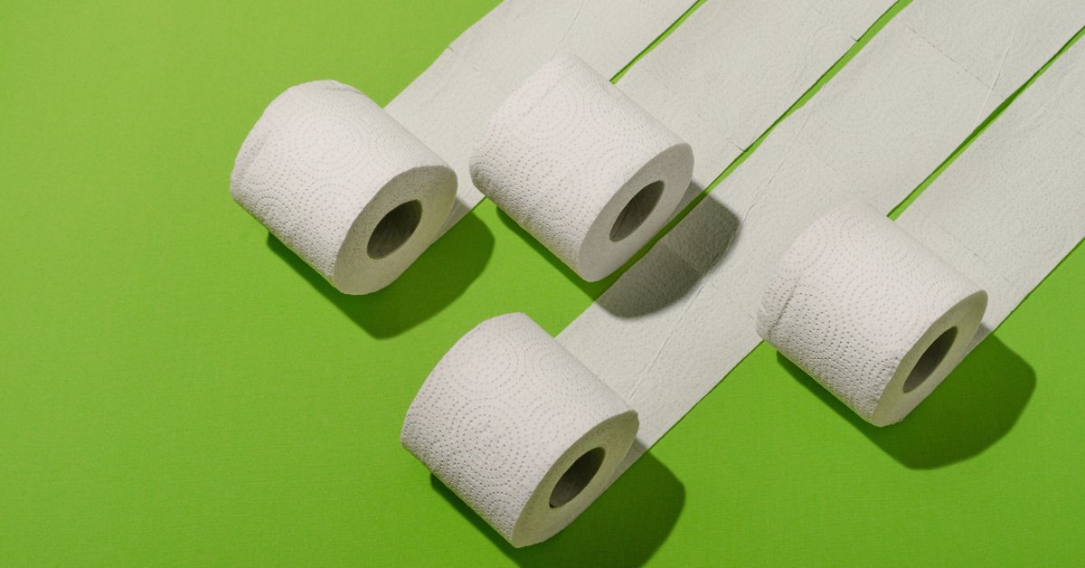 Four standard-sized rolls of toilet tissue are unrolling in a row on a bright lime green background.